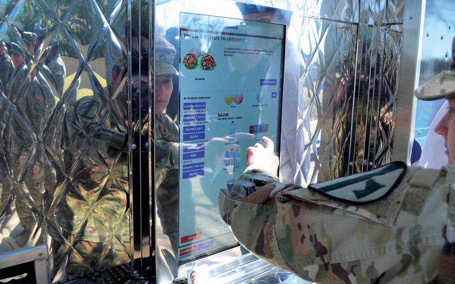 Staff Sgt. Victoria Corona orders a burrito from the touchscreen menu of the Culinary Outpost food truck Feb. 6, 2020, at Fort Hood, Texas. The truck is the Army's sixth and the first to offer a Tex-Mex menu. 