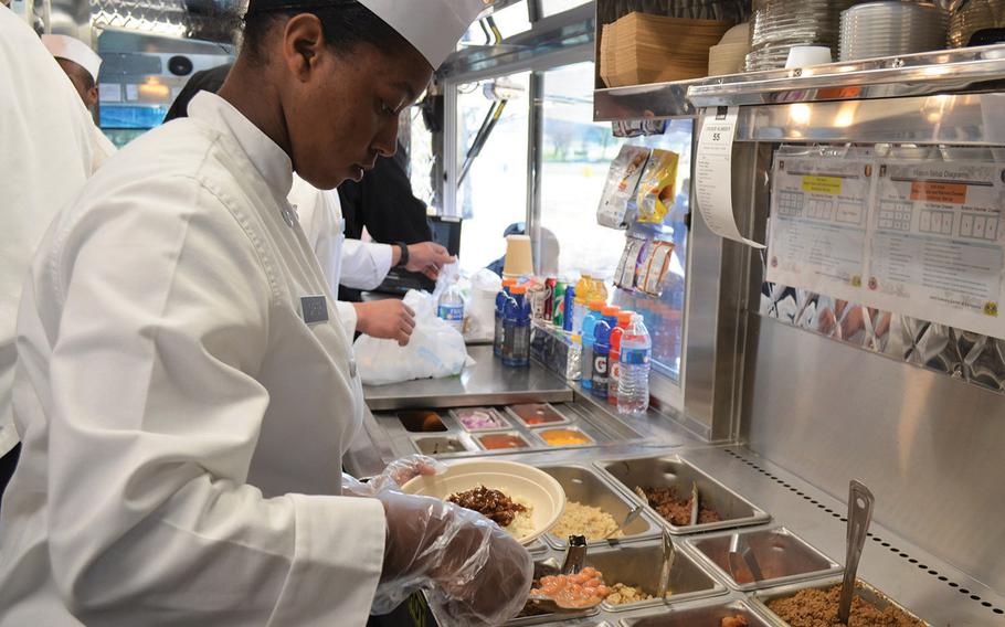 Pvt. Aniyaa Carter scoops pinto beans for a Tex-Mex burrito bowl Feb. 6, 2020, at Fort Hood, Texas. Though this is the Army's sixth food truck, Fort Hood's is the first to offer Tex-Mex menu items. 