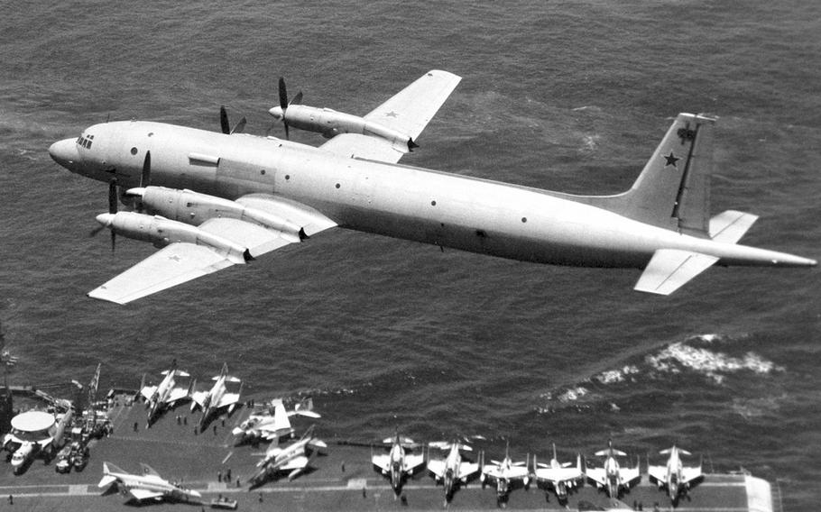 In a May, 1979 photo, a Soviet I1-38 May reconnaissance and anti-submarine warfare aircraft passes low over the flight deck of the aircraft carrier USS Midway.