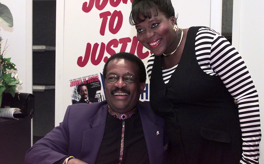 In a 1998 photo, Rica Greig of Kaiserslautern has her photo taken with famed attorney Johnnie Cochran at the Vogelweh Post Exchange in Kaiserslautern.