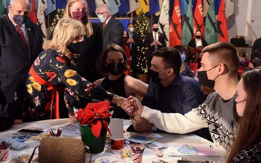 First lady Jill Biden shakes hands with two sailors, second and third from right, who are crew members of the USS Delaware, while visiting with families of the submarine crew Thursday, Dec. 9, 2021, at the U.S. Submarine Veterans Club in Groton. Secretary of the Navy Carlos Del Toro, left, looks on in the background. Biden is the sponsor of the submarine.  