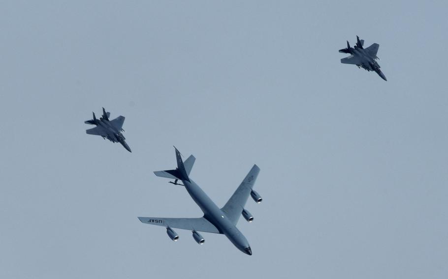 A U.S. Air Force KC-135 Stratotanker, assigned to the 100th Air Refueling Wing, RAF Mildenhall, U.K., distributes fuel to two U.S. Air Force F-15 Strike Eagles, assigned to the 48th Fighter Wing at RAF Lakenheath, during a large-force exercise over the North Sea, May 27, 2020. 
                