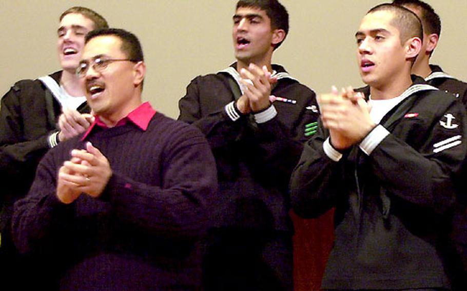 Members of the American choir clap as they sing "Go Tell it on the Mountain."