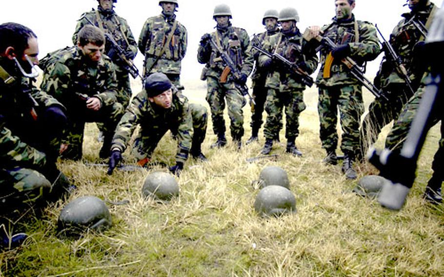 Platoon Leader Lt. Gia Ugrekhelidze, 1st Company, Georgian Commando Battalion, gives orders on attack procedures during a company level daylight attack at a training range in Vasiani, Georgia. 10th Special Forces Group is in Georgia conducting the Georgia Train and Equip Program, which will enhance Georgian soldiers abilities in various battlefield techniques.