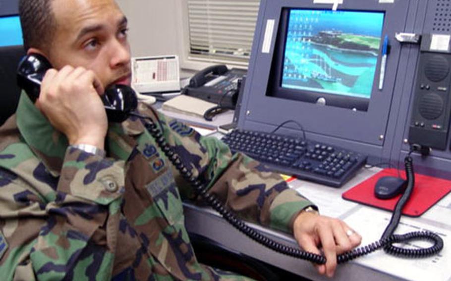 Staff Sgt. Jason Ellis, a senior emergency action controller, works the morning shift recently at Osan's new $13 million command center. The center allows for 30 percent more personnel plus touch-screen dialing for offices around base through the Pentagon and White House.