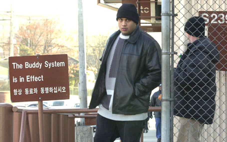 An off-duty soldier comes from on post with a friend Friday afternoon at Yongsan Garrison. Soldiers are advised to take a buddy when traveling off post.