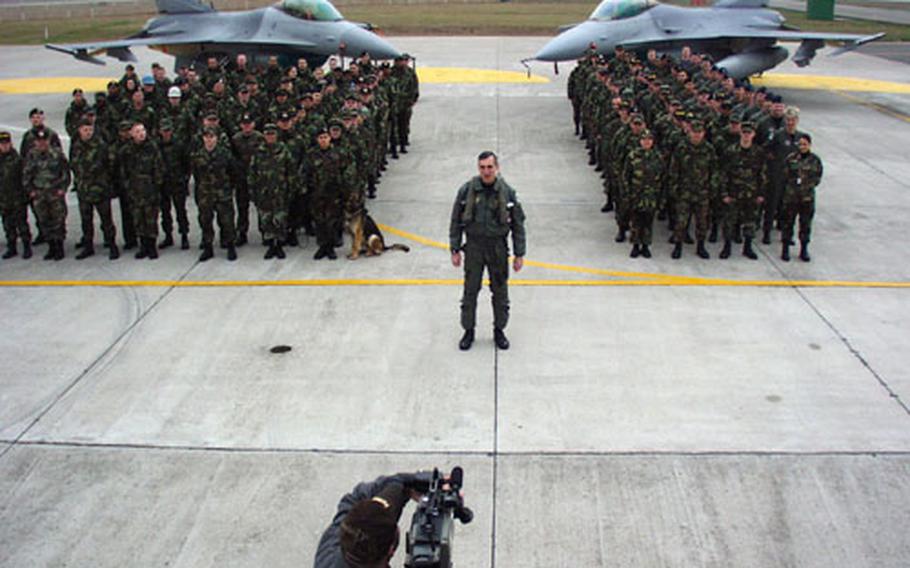 Brig. Gen. Mike Worden, a few hundred men and women (and one dog) of the 31st Fighter Squadron at Aviano Air Base, Italy, tape a message they hope will be broadcast during the telecast of the Super Bowl in January.