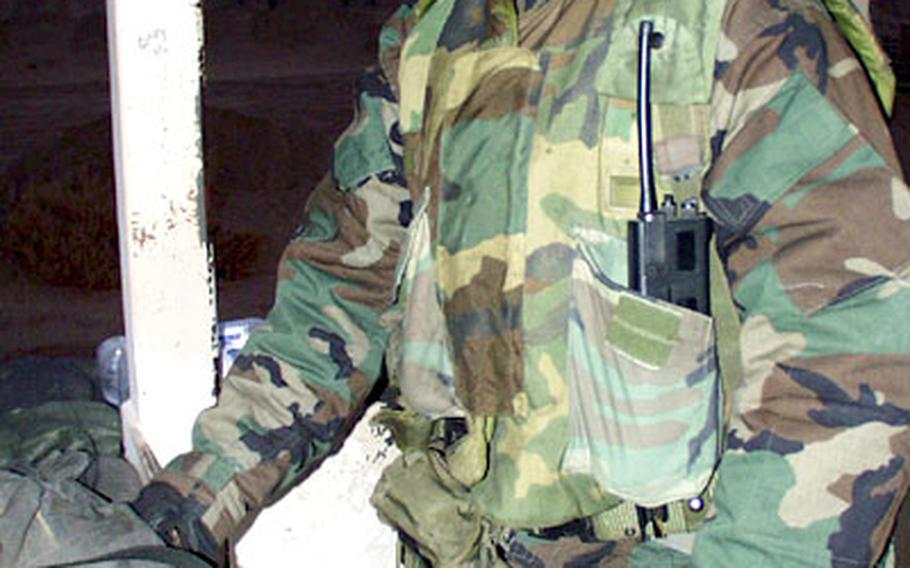 As dawn comes on New Year’s Day, Pfc. Jorge Betancur keeps watch from a guard tower on Camp Virginia in Kuwait.