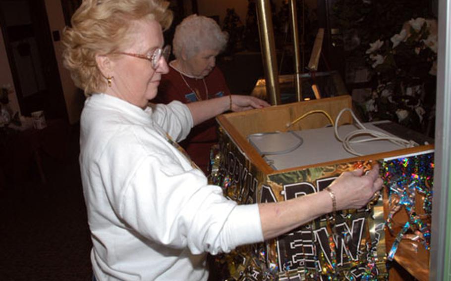 Yokota Air Base Officers' Club General Manager Linda Danner decorated the club's foyer Tuesday with her mother, Kathleen Powell, for the New Year's Eve party. The club was named best in the Air Force for fiscal 2001-02 and plans to expand its programs in 2003.