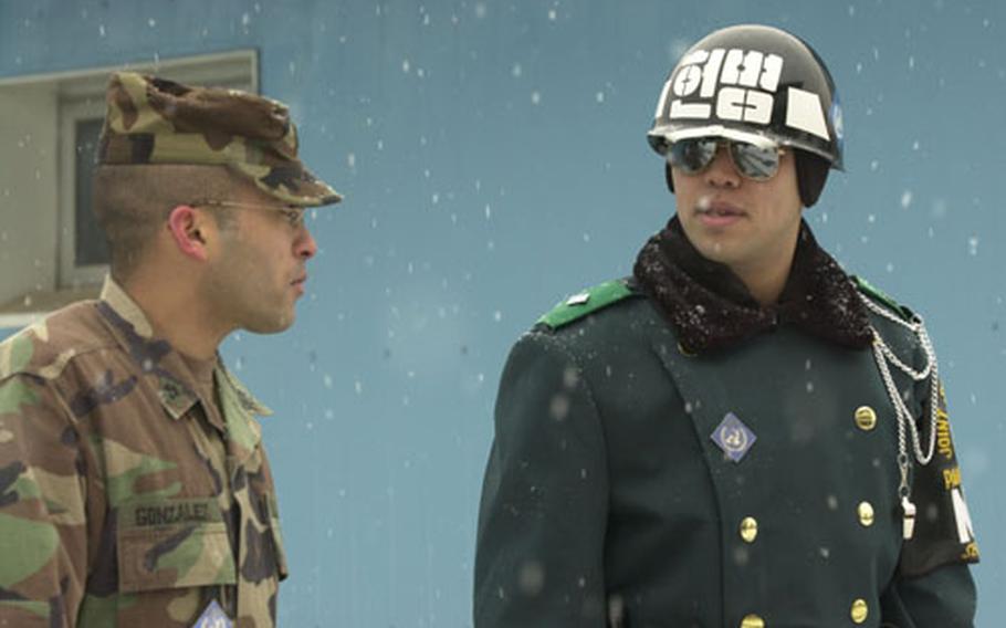 A South Korean and U.S. soldier brave the snow during guard duty at Panmunjom on Friday.
