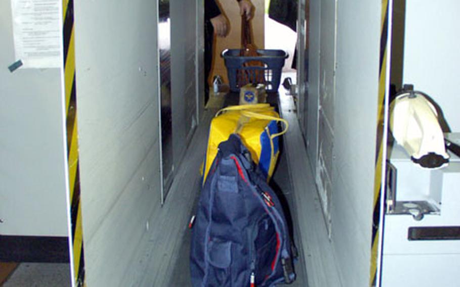 Passenger luggage runs through the X-ray machine at the Ramstein Air Base, Germany, before entering the terminal.