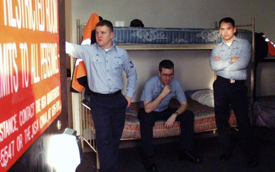 From left, Petty Officer 3rd Class Travis Rice, Seaman Dan Marsh and Seaman Jaime Castano hang out in their restricted barracks room at the Navy’s Capodichino base in Naples. The red sign on the door notes that the room is restricted. The room’s only furnishings are bunk beds, and sailors aren’t allowed to add any personal touches to the room or bring in personal belongings such as music or computers.