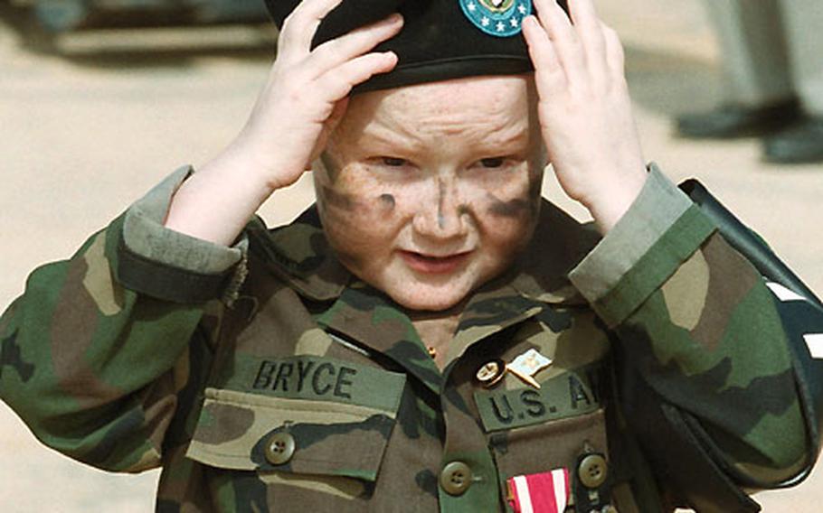 Justin Bryce, 10, adjusts his beret given to him by the Army. The Make-A-Wish Foundation helped the terminal cancer patient make his military wish a reality before his death on Christmas Day.