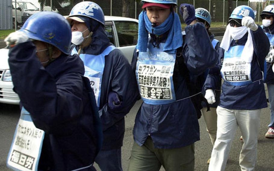 U.S. military action in the war on terror, expected to draw protestors this weekend, also has drawn protests in the past. Above, about 100 protesters marched near Sasebo Naval Base in November 2001, protesting Japanese participation in the war on terrorism in Afghanistan. Protests are expected throughout Japan this weekend as part of international demonstrations against any possible U.S. war against Iraq.