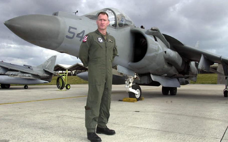 Marine Lt. Col. Rob Kuckuk of Marine Attack Squadron 214, the Black Sheep Squadron, stands before an AV-8B Harrier at Kadena Air Base.