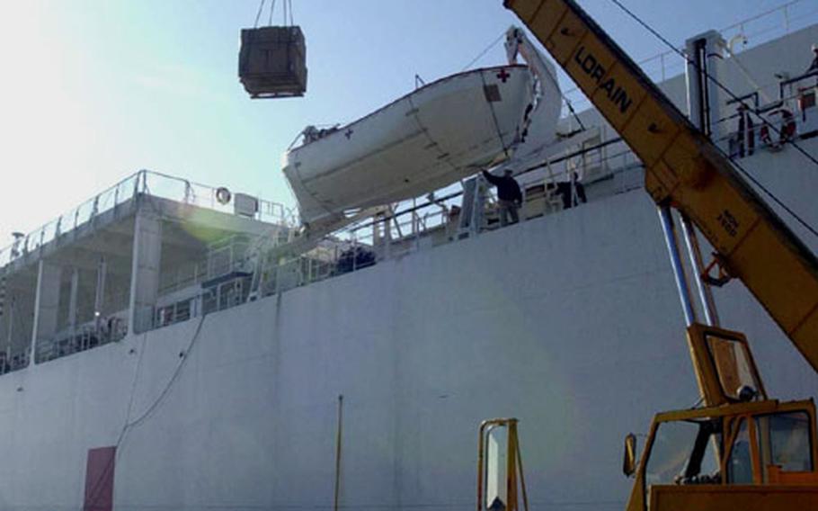 A crane is used to load supplies onto the U.S. Navy hospital ship USNS Comfort. The ship stopped in Rota this weekend to get supplies before heading to the Middle East.