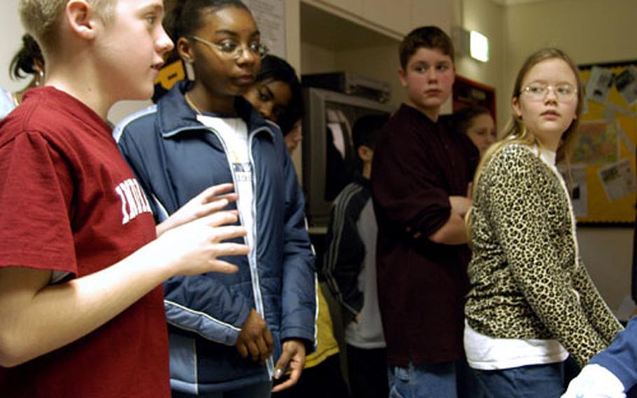 His classmates listen as Heidelberg Middle School seventh-grader Eric Finke, 13, left, discusses his thinking on Islam in one of teacher Sylvia Rausch's seventh-grade geography classes. With many parents of DODDS students deploying to the Middle East, Rausch is weaving current events in with the geography and the history of the area, so the kids have a better understanding of where their parents might be going.