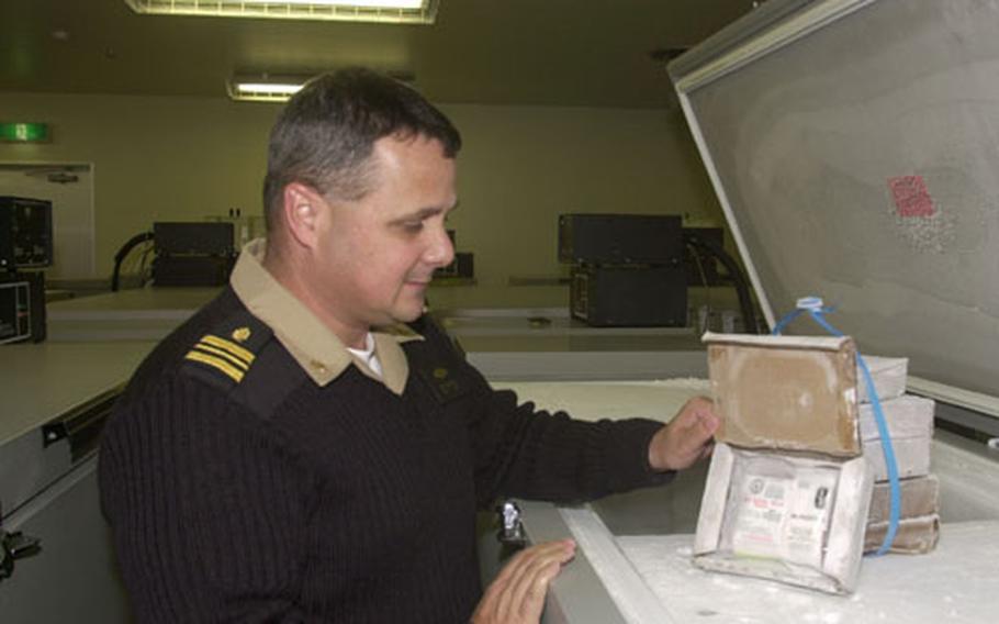 Navy Lt. Cmdr. John Van Patten hold a packet of frozen blood at the Armed Services Blood Bank Center on Okinawa.