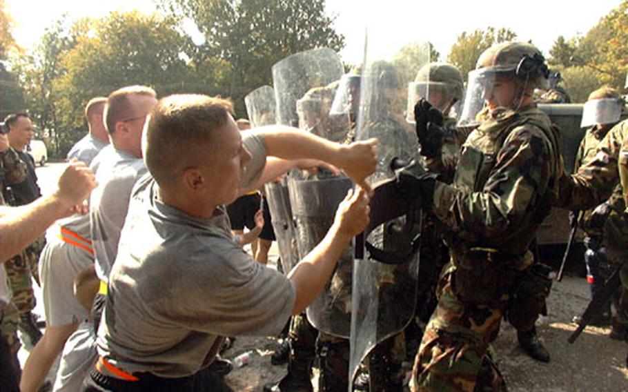 28th Infantry Division soldiers serving with Stabilization Force protect a police station against "rioters" during October's non-lethal weapons training on Eagle Base. The troops were trained to assist the local police in controlling potential riots. The soldiers are now scheduled for peacekeeping duties in Kosovo.