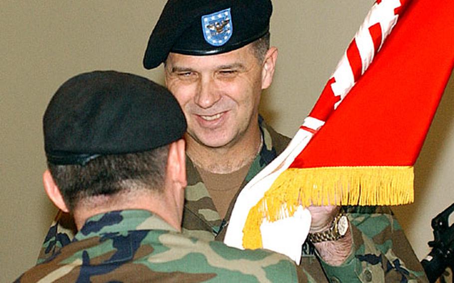 Col. William H. McCoy, facing the camera, receives the just-unfurled colors of the 18th Engineer Brigade from Maj. Gen. Anthony R. Jones, USAREUR chief of staff. McCoy is the brigade’s commander. The brigade will be headquartered at Campbell Barracks in Germany.