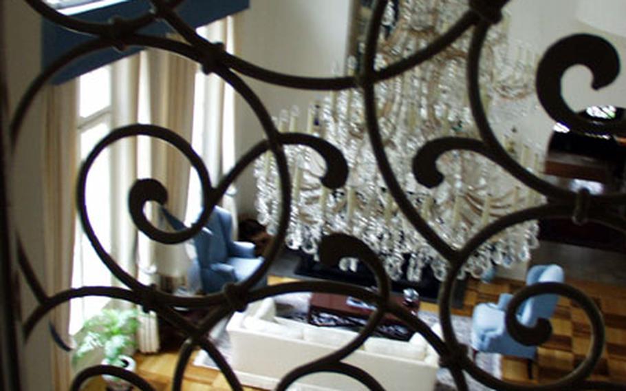 A file photo of the formal living room in the mansion that is used to house the U.S. European Command deputy commander in chief. The chandeliers and grand piano are part of the permanent furnishings.
