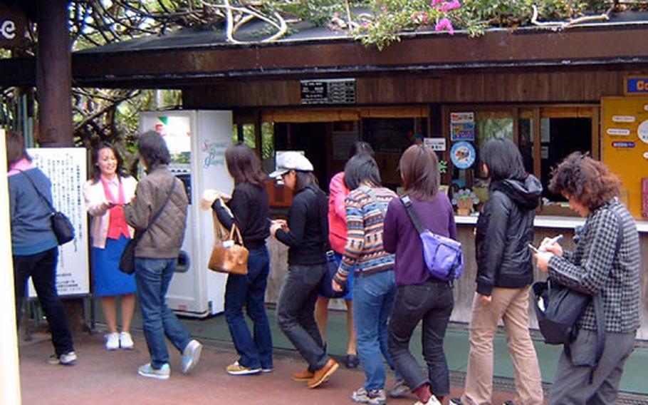 Tourists from mainland Japan file into Okinawa's Southeast Botanical Gardens Thursday. Last year was a record year for tourism on Okinawa.