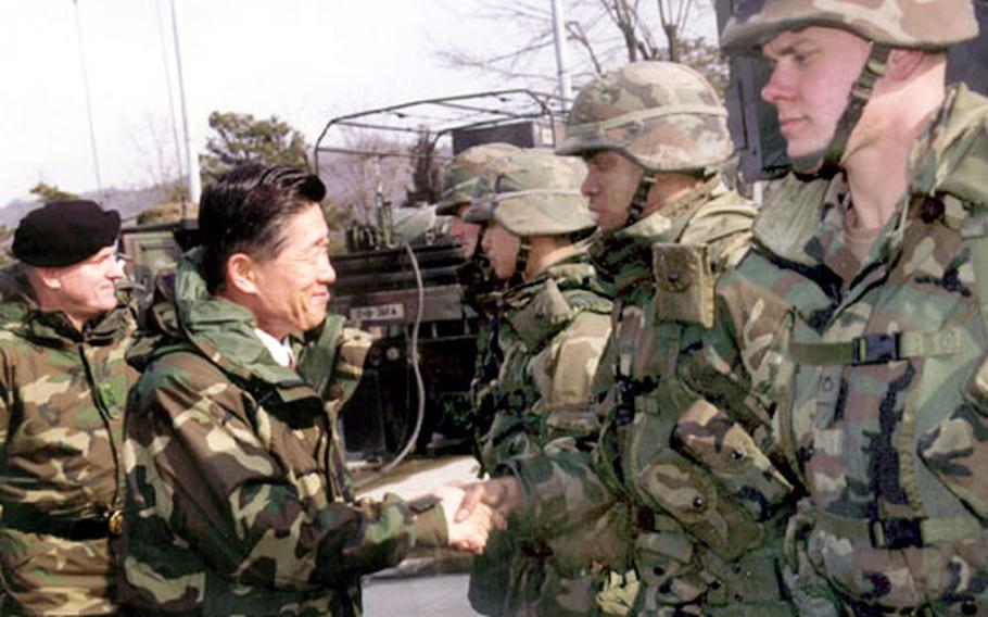 South Korean Defense Minister Lee Jun meets with U.S. troops Tuesday at Camp Stanley. Lee told U.S. soldiers to be tolerant of the changing sentiments of South Korean people.