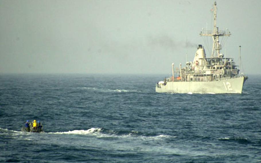 A rigid-hulled inflatable boat aproaches a Polish frigate, part of the coalition enforcing U.N. sanctions in the Persian Gulf. Ships from the United States, Britain, Austraiia and Poland are on patrol stopping smugglers leaving Iraqi waters with banned cargo.