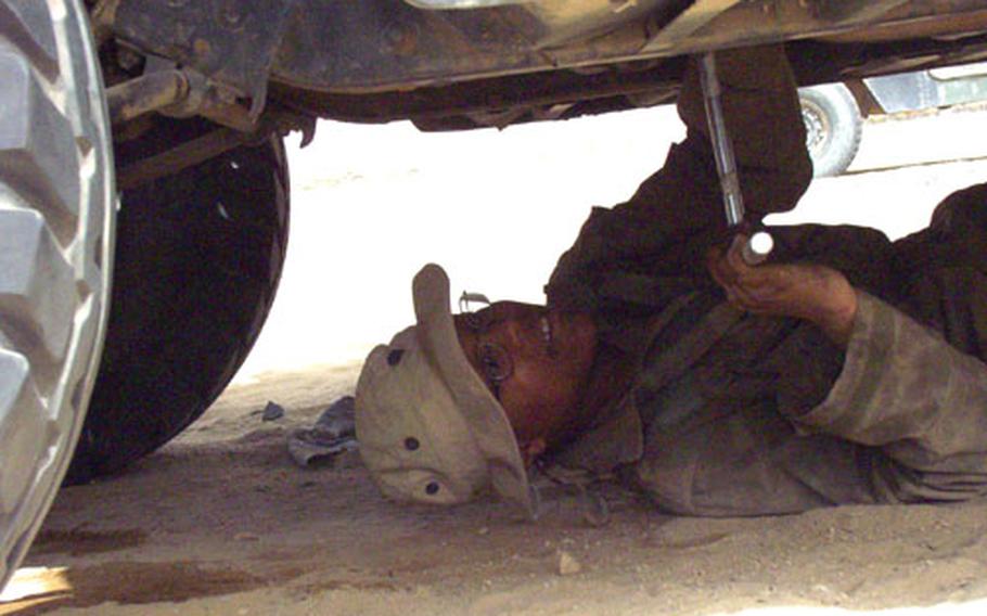 Spc. Shavon Harris, 19, of Watterboro, N.C., is a mechanic with the 147th Maintenance Company who gets covered with grime and dust as part of her job at Camp Udairi, Kuwait.