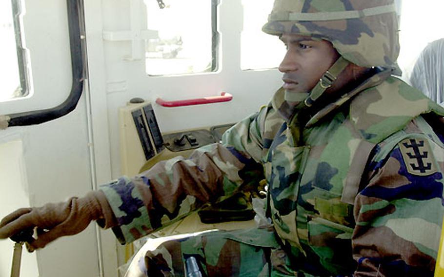 Sgt. Jerel Moses, of the 94th Engineer Support Battalion, gets used to operating the new D9 dozer at Camp Virginia, Kuwait. It will replace the older D7 version.