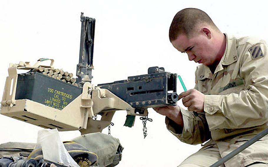 Pvt. Brian Bollan, 19, from Detroit, Mich., readies his equipment on his Humvee gunner position. Bollan serves in the 3rd Infantry Division’s 1st Battalion, 15th Infantry Regiment scout platoon.