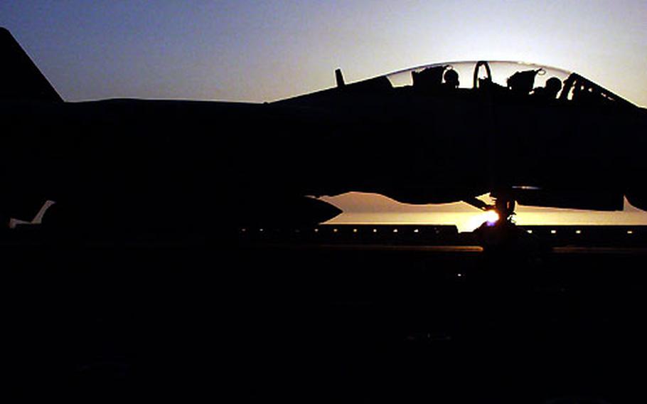 An F-14 Tomcat takes off from the USS Kitty Hawk as the sun sets over the Persian Gulf on Tuesday.