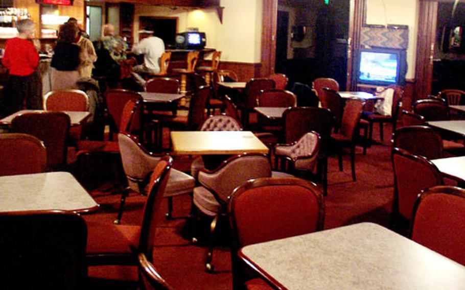 The Kelley Community Club is nearly empty during a recent Friday night happy hour, when free food is served. Business has been drastically down at this club and others after the 6th Area Support Group instituted a smoking ban from all facilities. Smokers must be at least 50 feet away from a building to smoke.