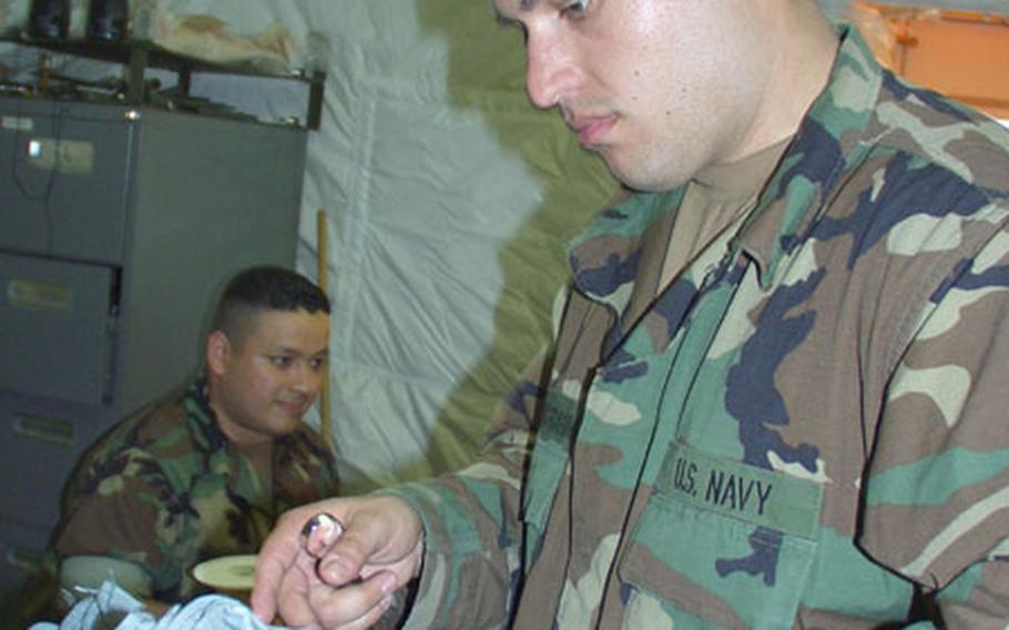 Navy Petty Officer 2nd Class Alireza Amirzadehebrahimi prepares some dental equipment Monday at a field hospital in Rota, Spain. Navy doctors and nurses with Fleet Hospital Eight moved from a 116-bed field hospital into a new 250-bed tent facility at Naval Station Rota on Monday.