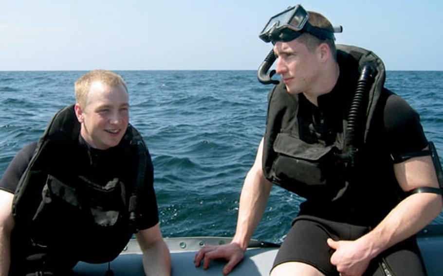 Petty Officer 3rd Class Alan Harmon, a sonar technician and rescue swimmer, left, and Petty Officer 3rd Class Chris Stern, a turbine mechanic, helped rescue eight Iraqis.