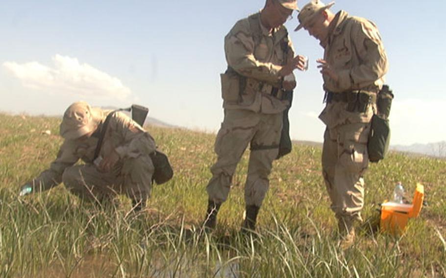 On Thursday, Air Force Tech. Sgt. Heinz Kiefer (left), Maj. James Poel and Capt. Ron Allen gathered water and examined larva to determine if a particular type of mosquito, one known for being a carrier of the malaria parasite, is present and a threat to the airmen and soldiers camped at the airfield. The three are assigned to the 86th Contingency Response Group’s Environmental Medicine Flight from Ramstein Air Base, Germany.