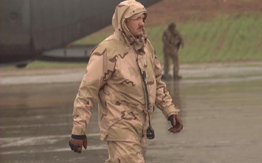 That wacky Iraqi weather has made flight line duty at Bashur Airfield in northeastern Iraq a challenge. Over the past couple of weeks, the airmen of the 86th Contingency Response Group and soldiers of the 173rd Airborne Brigade have experienced extreme cold, extreme heat, strong winds, rain, hail and a sandstorm. On this day, Air Force Master Sgt. David "Baldy" Baldridge, a mission support team chief for the 86th Air Mobility Squadron, Ramstein Air Base, Germany, carries on with the businesss of helping to unload a C-130 Hercules.