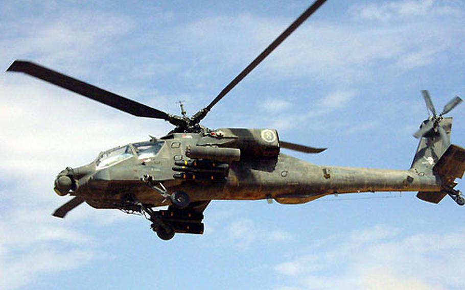 Chief Warrant Officer 3 Tim McCray and Chief Warrant Officer 2 Aaron Mitchell lift their AH-64A Apache off the ground en route to a mission against the former stronghold of the Iraqi Republican Guard's Medina Division south of Baghdad. The pilots are members of the 2nd Squadron, 6th Cavalry Regiment's Troop C.