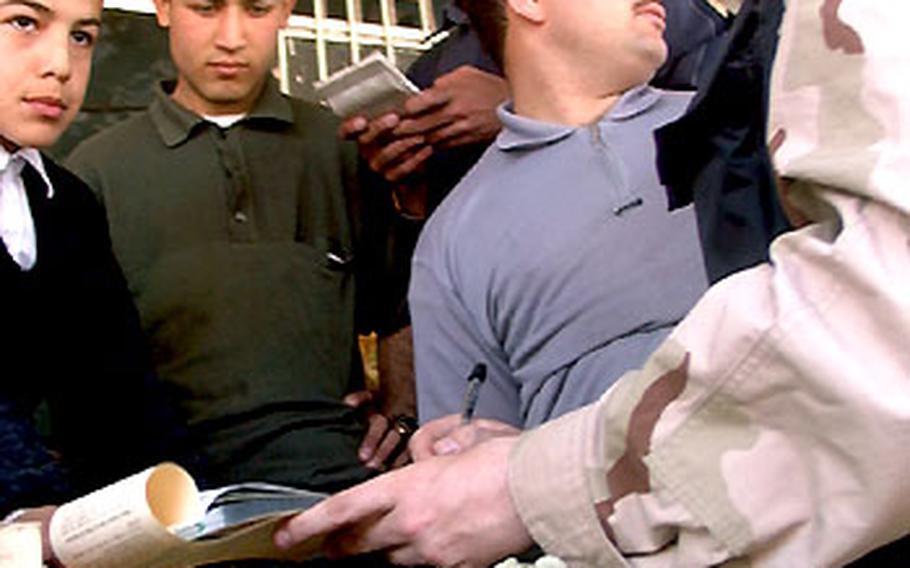 Air Force Staff Sgt. Brent Goe, a contractor, buys fruit from a vendor in the northern Kurdish city of Sallahadin, Iraq.