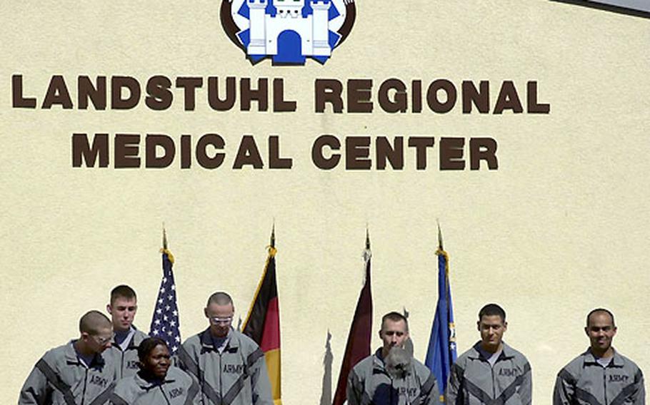 The seven former U.S. POWs greet the international media from a balcony at Landstuhl Regional Medical Center, Germany, on Friday.