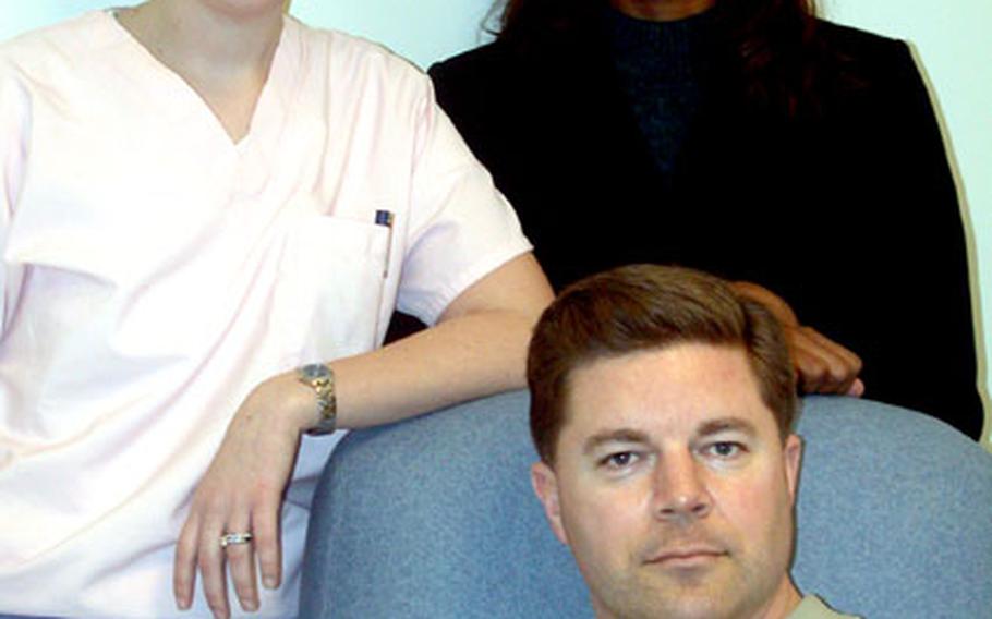 Master Sgt. Kristofer Carlson, seated, has been tapped to be a bone marrow donor for a 32-year-old unidentified man suffering from leukemia. He traveled to Washington, D.C., last week for additional health tests and to meet with the surgeon who will perform the procedure of harvesting his marrow, Dr. Tamarro Taylor, right, and Jennifer Wilder, the donor coordinator for Georgetown University Hospital, where the May 8 surgery will take place.