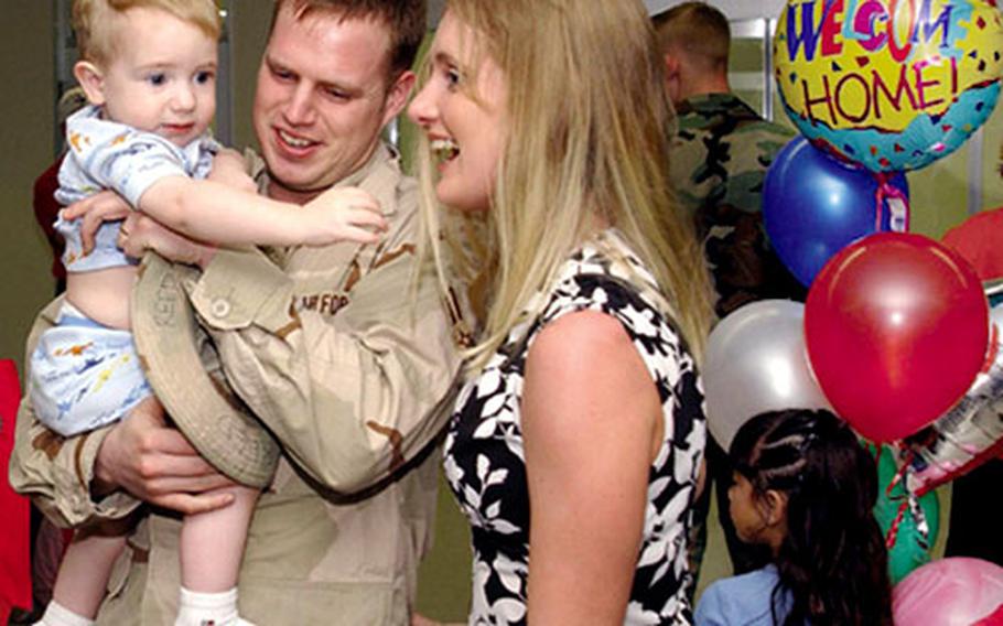 Airman 1st Class Richard Reed, a 67th Fighter Squadron weapons load crewmember, receives a welcome home from his wife, Tina, and son, Sonny, after returning from a 125-day Air Expeditionary Force deployment last week.