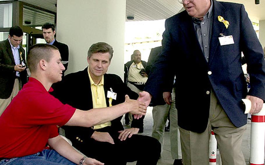 Speaker of the House Dennis Hastert, right, and Rep. William Tiahrt, R-Kan., center, speak with Pfc. Paul Lawhorn, who was injured in Iraq, outside the Landstuhl Regional Medical Center on Monday.