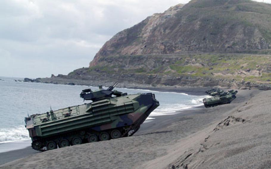 Amphibious Assault Vehicles line the beach below Mount Suribachi on the island of Iwo Jima in a static display for the 58th Anniversary of the Battle of Iwo Jima Commemoration, March 12. Marines on Okinawa are investigating the accidental sinking of an AAV April 17 during a loading exercise in the waters of northeast Okinawa, near Camp Schwab.