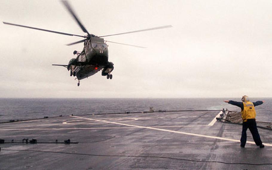 A UH-3H Sea King helicopter from HSL-51 prepares to land on the deck of the USS Blue Ridge at sea. The Atsugi, Japan-based squadron earned a Battle "E" for 2002, the fifth time it has won the award in the unit's 11-year history.