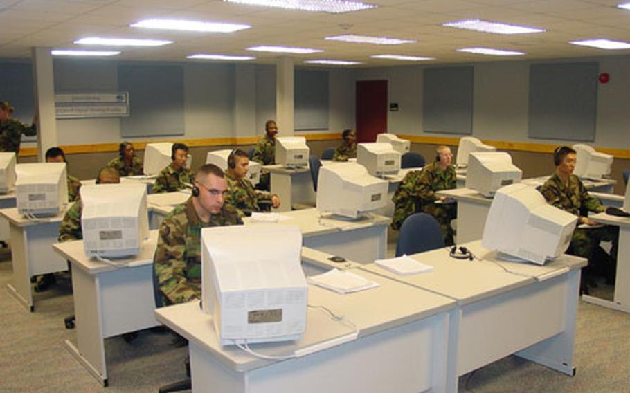 At Camp Carroll in Waegwan, South Korea, soldiers take military training course using computers and other high-tech gear at recently opened Digital Training Facility.