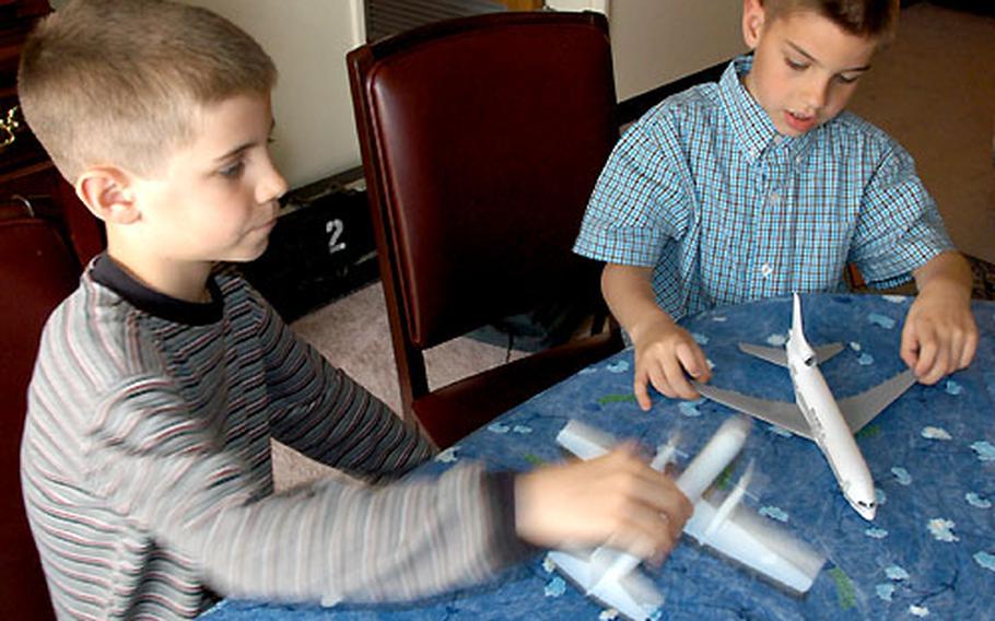 David, left, and Dominic Nordel build model airplanes instead of watching television.