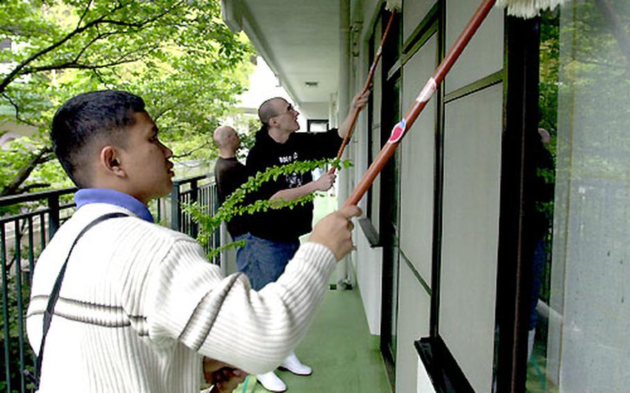 Sailors from the USS Carl Vinson clean the windows of a Yokosuka, Japan, nursing home as part of a community relations project Tuesday. Some sailors have been spending their port-call time helping others.