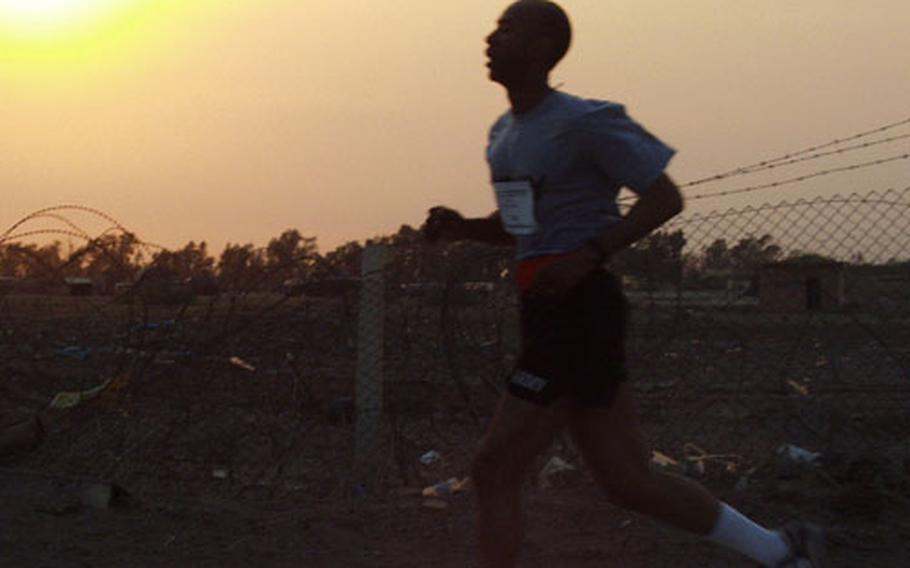 Reginald Smith, the command sergeant major of the 2nd Battalion, 501st Aviation Regiment, nears the end of his 5-kilometer run Friday at Baghdad International Airport. Smith’s battalion sponsored the race, which started a day of sports, food and general celebration of the Fourth of July.
