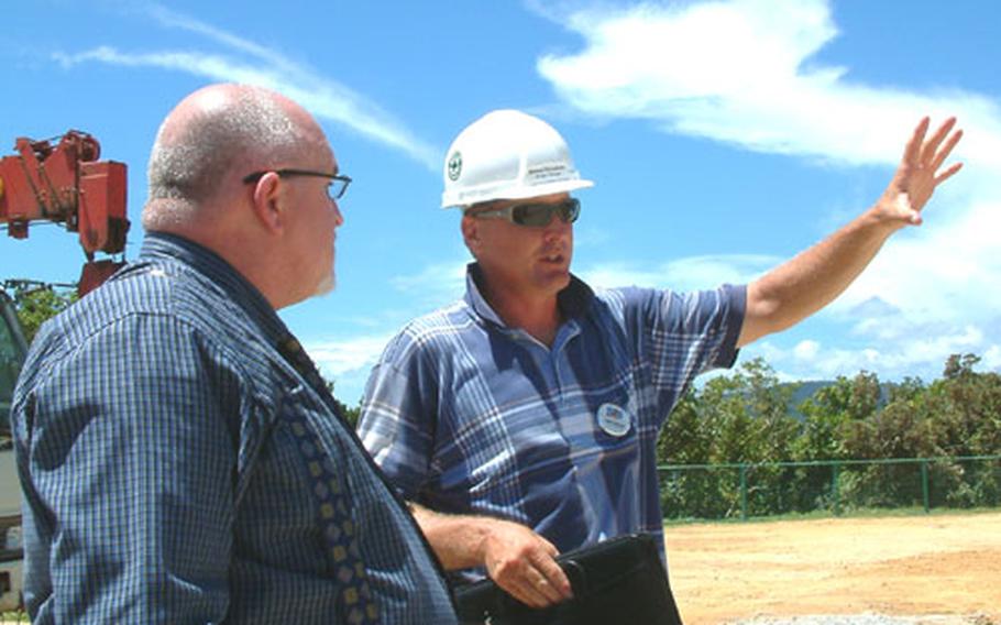 Project manager Delane Rivenbark, right, goes over construction plans for the Cottages at Oura Wan Beach with Ray Welch, the MCCS camp coordinator for Camp Schwab.